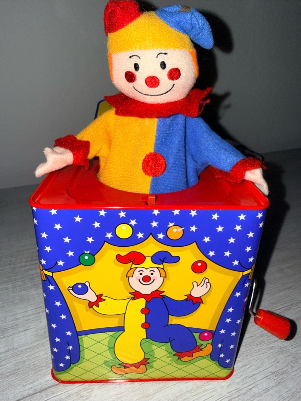 Colorful Yellow & Blue Jack-in-the-Box Clown Toy schilling